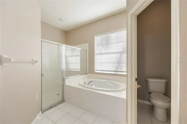 a spacious bathroom with a double vanity sink mirror and a bathtub