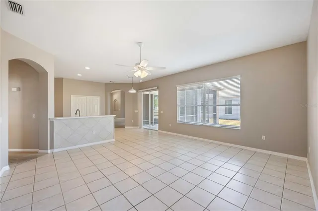 a spacious bathroom with a toilet sink and mirror