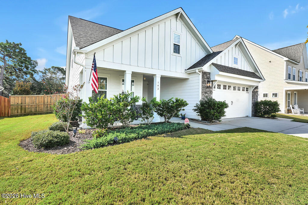 142 Rice Marsh Way Wilmington, NC 28412 - Photo 2 of 64 A fully irrigated yard and attractive landscaping make this front porch shine.
