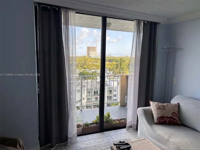 a bedroom with bed and glass window