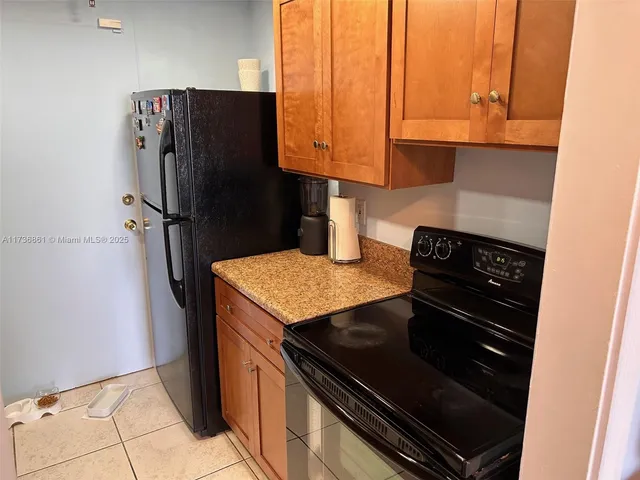 a kitchen with stainless steel appliances granite countertop a refrigerator and a stove