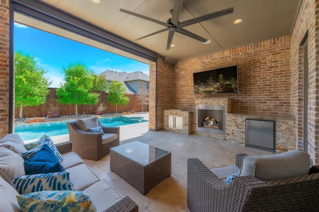 a living room with furniture a flat screen tv and a fireplace