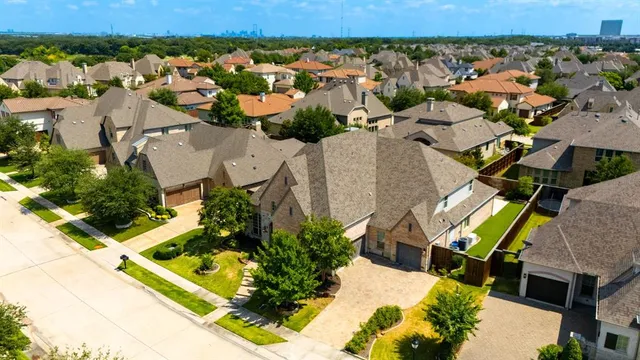 an aerial view of residential houses with outdoor space