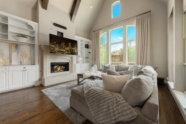 a living room with furniture a flat screen tv and a fireplace
