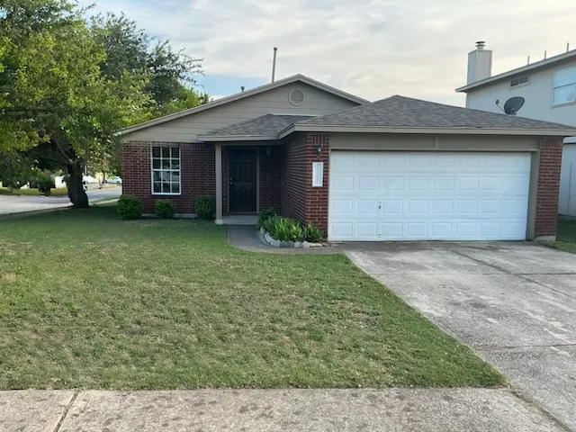 a front view of a house with a garden and yard