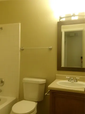a bathroom with a sink a toilet and mirror