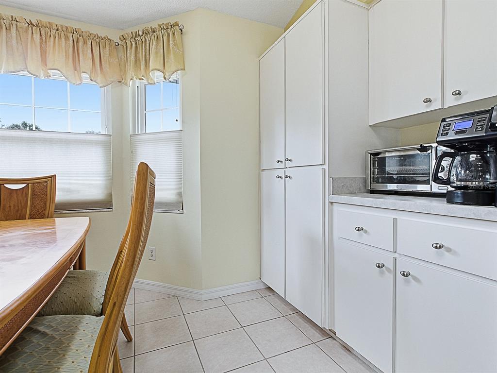 5588 Gulf Stream Street Tavares, FL 32778 - Photo 15 of 44 a kitchen with stainless steel appliances granite countertop a refrigerator and a stove top oven
