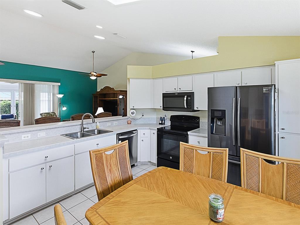 5588 Gulf Stream Street Tavares, FL 32778 - Photo 16 of 44 a kitchen with cabinets a sink and appliances