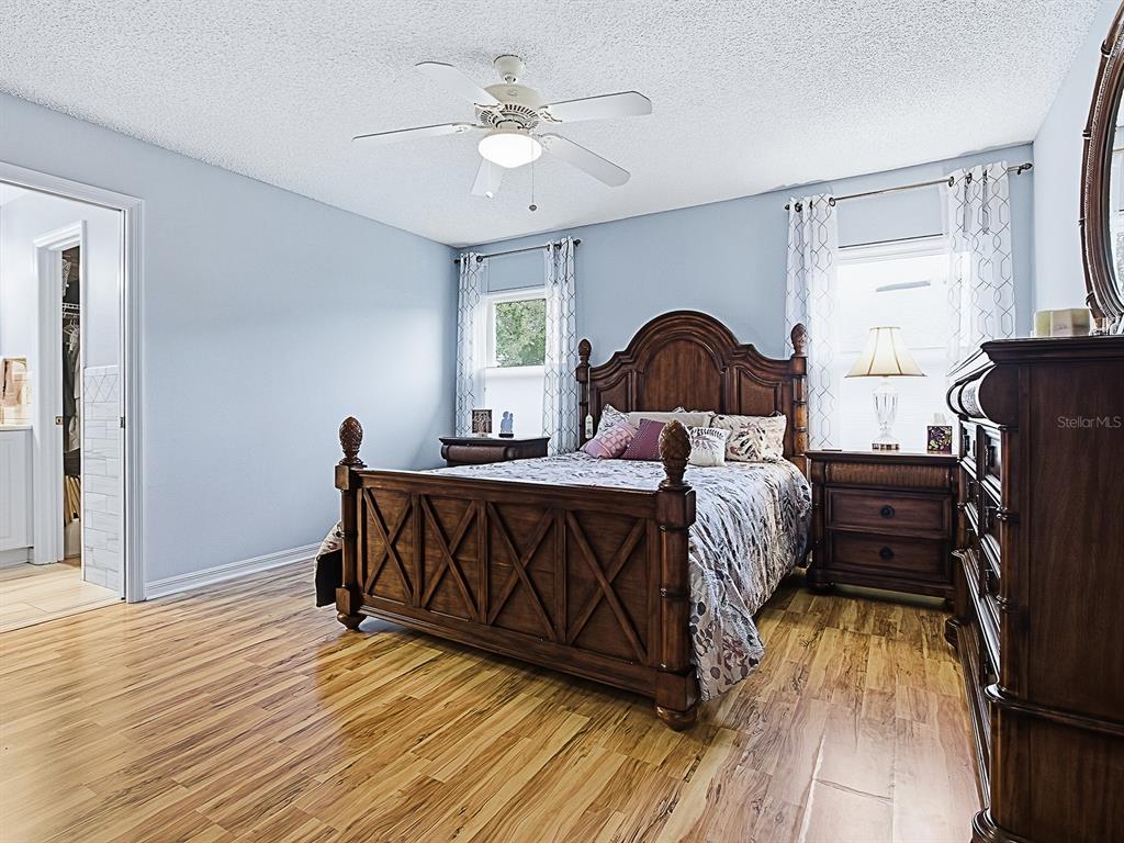 5588 Gulf Stream Street Tavares, FL 32778 - Photo 17 of 44 a bedroom with a bed and a chandelier