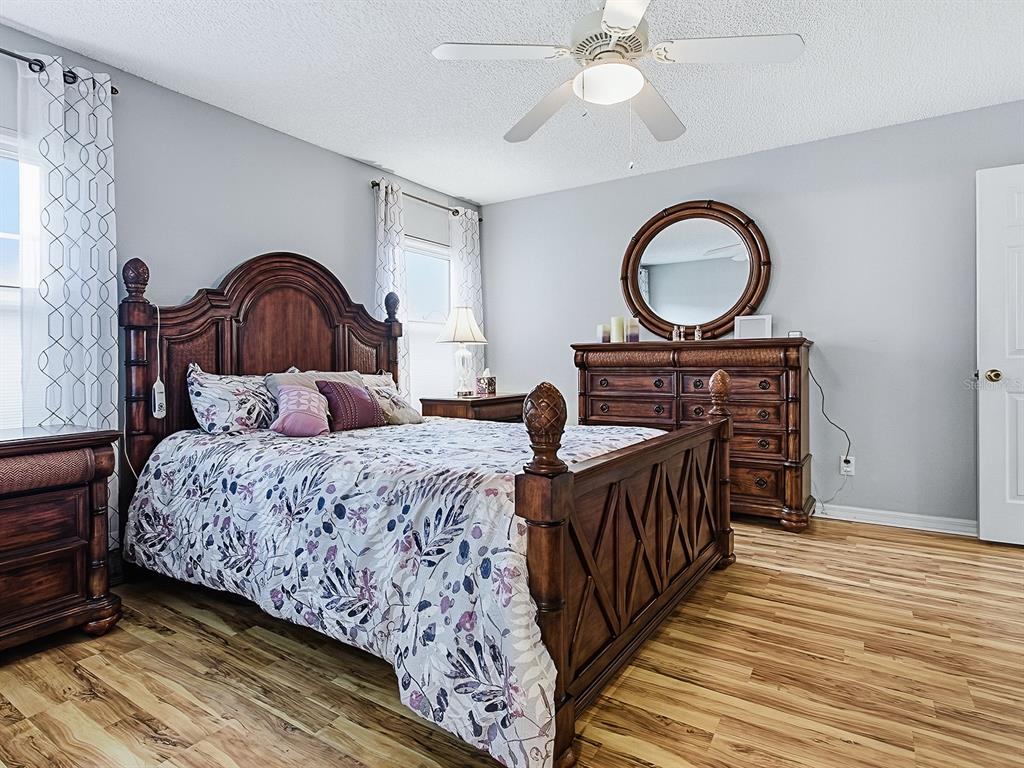 5588 Gulf Stream Street Tavares, FL 32778 - Photo 18 of 44 a bedroom with bed and wooden floor