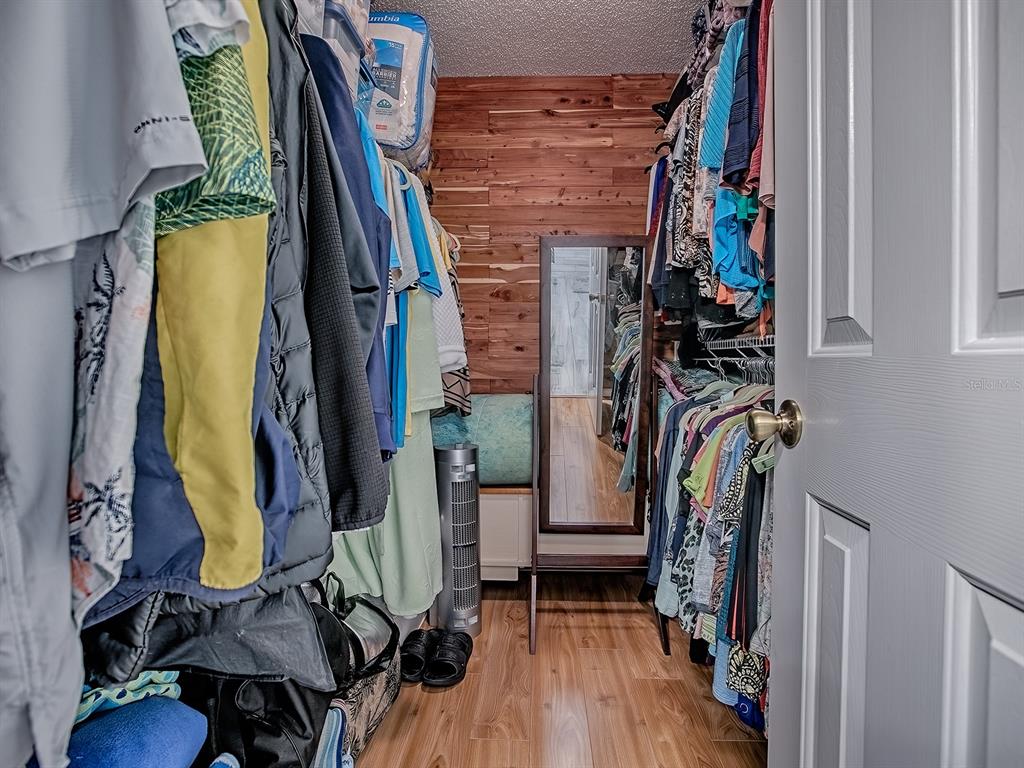 5588 Gulf Stream Street Tavares, FL 32778 - Photo 24 of 44 a view of walk in closet with clothes