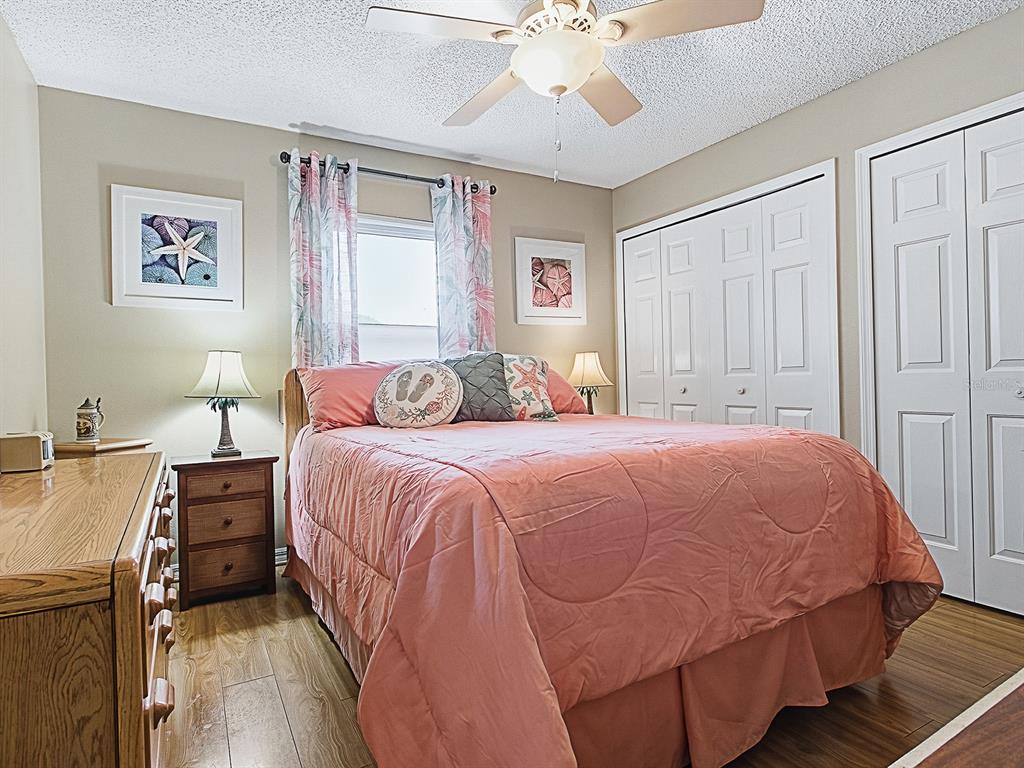 5588 Gulf Stream Street Tavares, FL 32778 - Photo 25 of 44 a bedroom with a bed and a chandelier