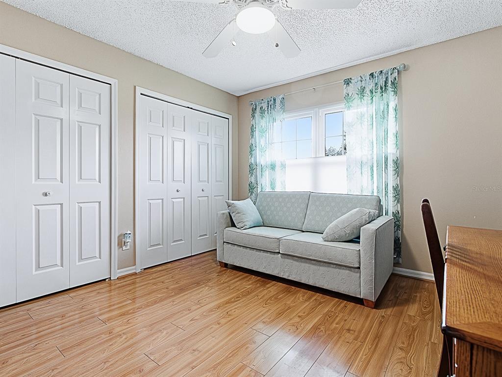 5588 Gulf Stream Street Tavares, FL 32778 - Photo 28 of 44 a living room with furniture and a wooden floor