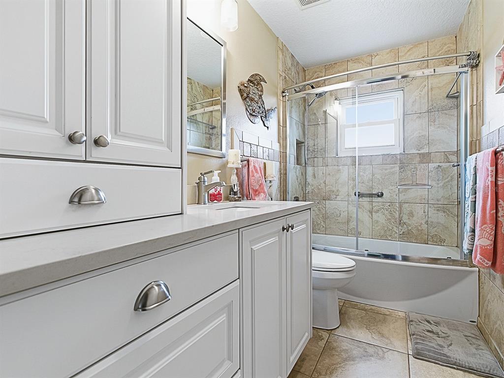 5588 Gulf Stream Street Tavares, FL 32778 - Photo 29 of 44 a bathroom with a sink a toilet and shower