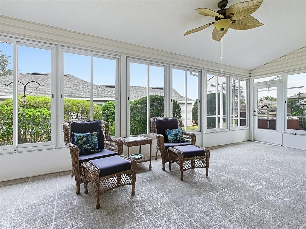 5588 Gulf Stream Street Tavares, FL 32778 - Photo 31 of 44 a living room with furniture a ceiling fan and a large window