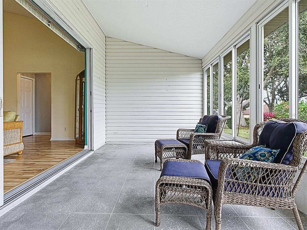 5588 Gulf Stream Street Tavares, FL 32778 - Photo 32 of 44 a balcony view with a couch and wooden floor