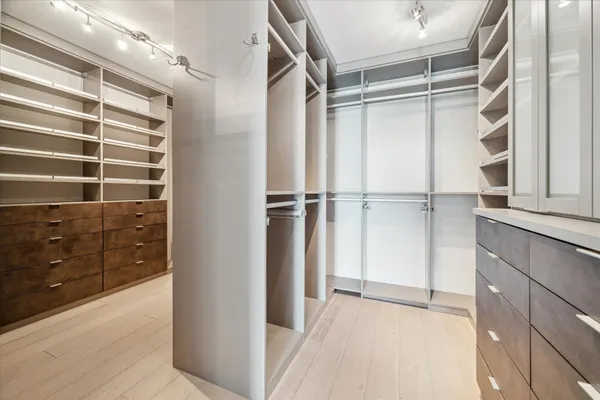 a spacious bathroom with a shower sink and mirror