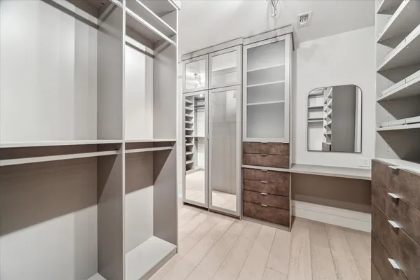 a spacious bathroom with a double sink shower and a mirror