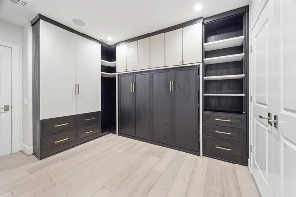 a view of walk in closet with empty racks