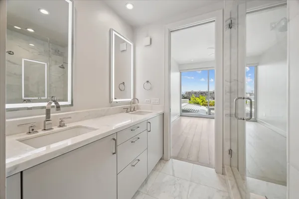 a kitchen with stainless steel appliances granite countertop a sink a stove and a refrigerator