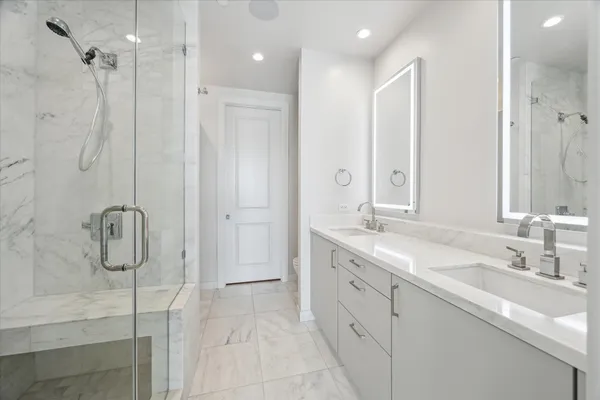 a spacious bedroom with a large bed and a flat screen tv