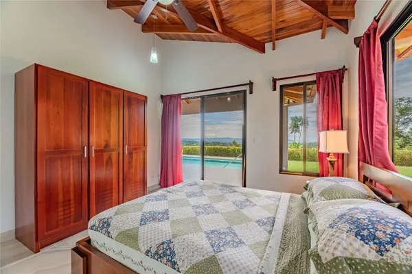 a bed sitting in a bedroom next to a window