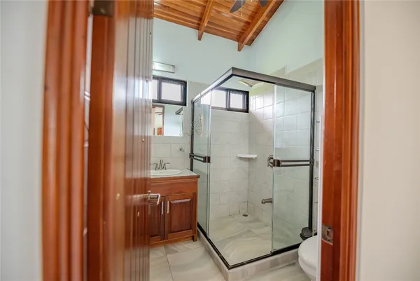 a bathroom with a glass shower door and mirror