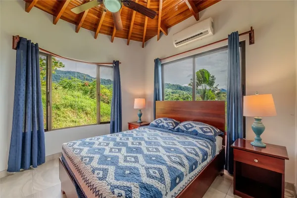 a bedroom with a bed dresser and a window