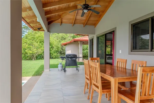 a dining room with furniture and a garden