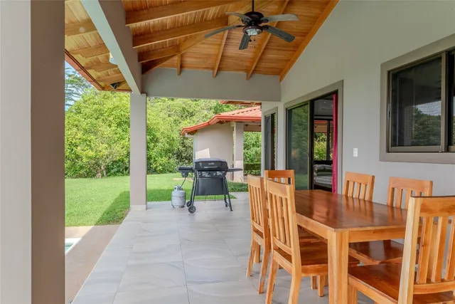a dining room with furniture and a garden