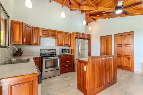 a kitchen with stainless steel appliances granite countertop a stove a sink dishwasher and a refrigerator