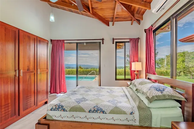 a bed sitting in a bedroom next to a window