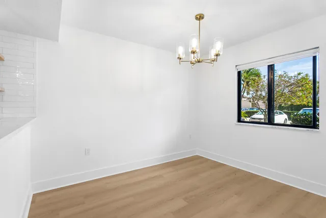 a view of a kitchen with a sink and a refrigerator