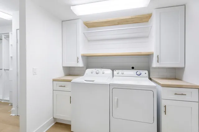 an aerial view of a residential houses with a swimming pool