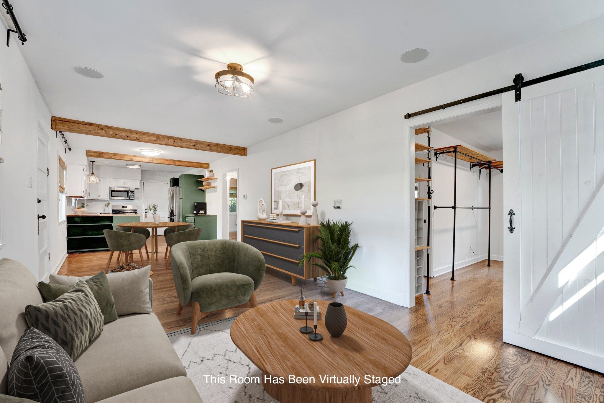 1300 Mullins Station Road Memphis, TN 38134 - Photo 8 of 34 Living room featuring beamed ceiling, a barn door, and light wood-type flooring