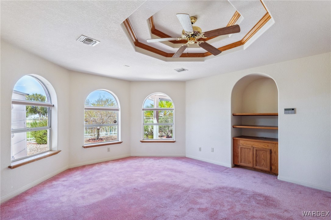 5967 Mountain View Road Fort Mohave, AZ 86426 - Photo 11 of 18 an empty room with windows and ceiling fan