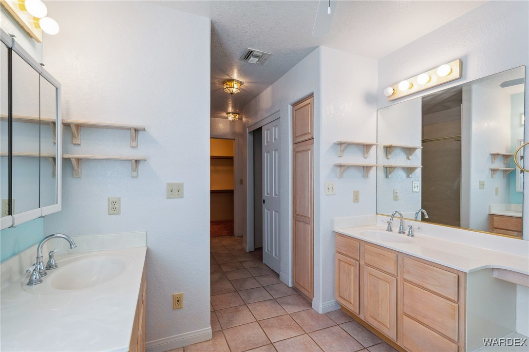 5967 Mountain View Road Fort Mohave, AZ 86426 - Photo 12 of 18 a bathroom with a double vanity sink and a mirror