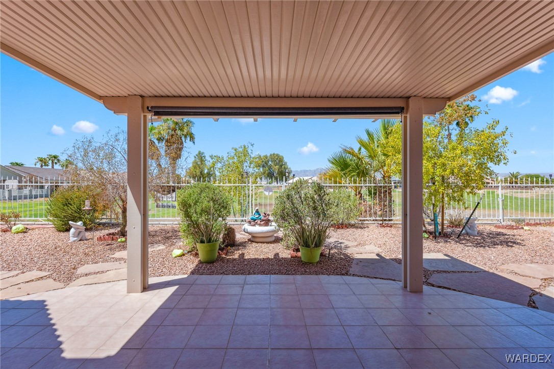 5967 Mountain View Road Fort Mohave, AZ 86426 - Photo 17 of 18 a porch with a table and chairs and potted plants