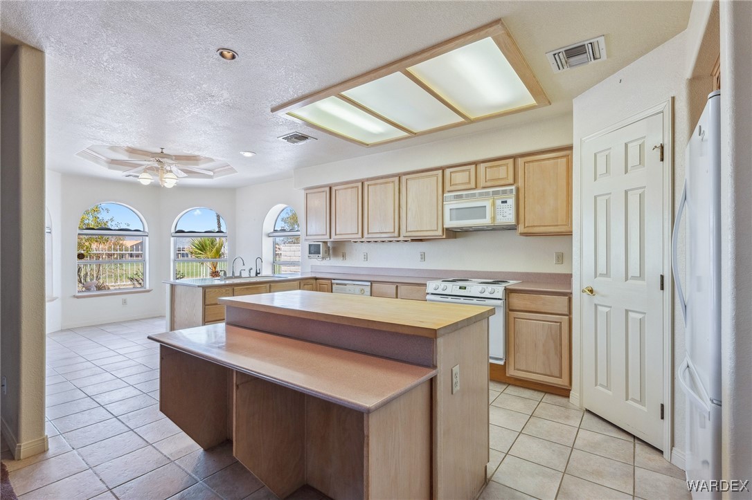 5967 Mountain View Road Fort Mohave, AZ 86426 - Photo 3 of 18 a kitchen with stainless steel appliances granite countertop a sink and cabinets