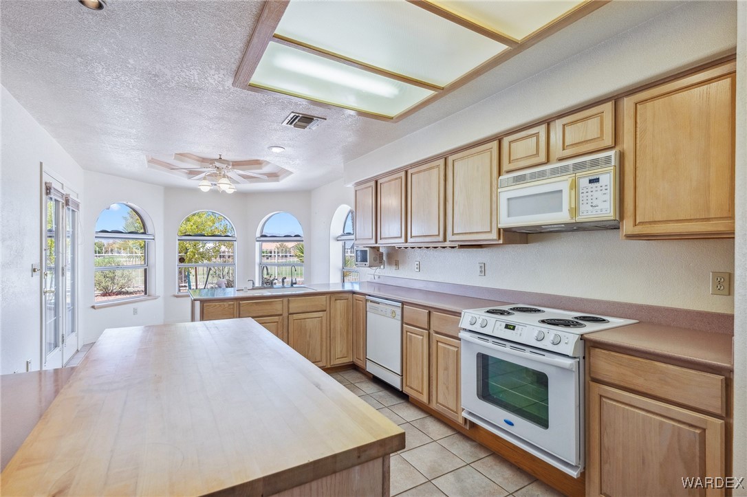 5967 Mountain View Road Fort Mohave, AZ 86426 - Photo 4 of 18 a kitchen with stainless steel appliances granite countertop a stove and cabinets