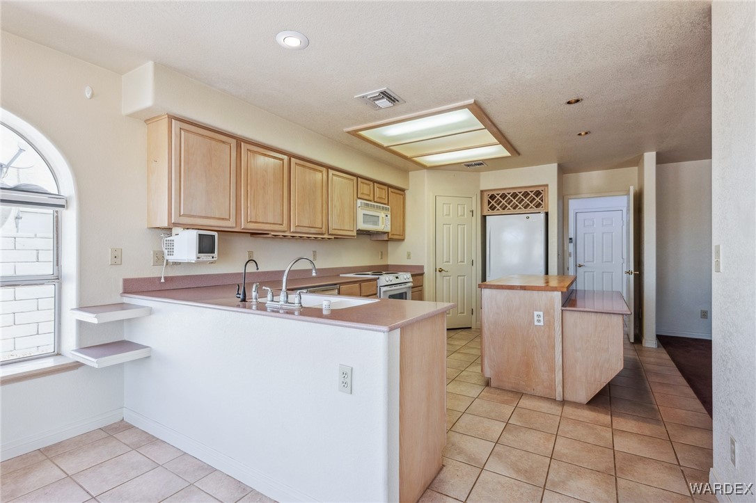 5967 Mountain View Road Fort Mohave, AZ 86426 - Photo 6 of 18 a kitchen with a sink cabinets and window