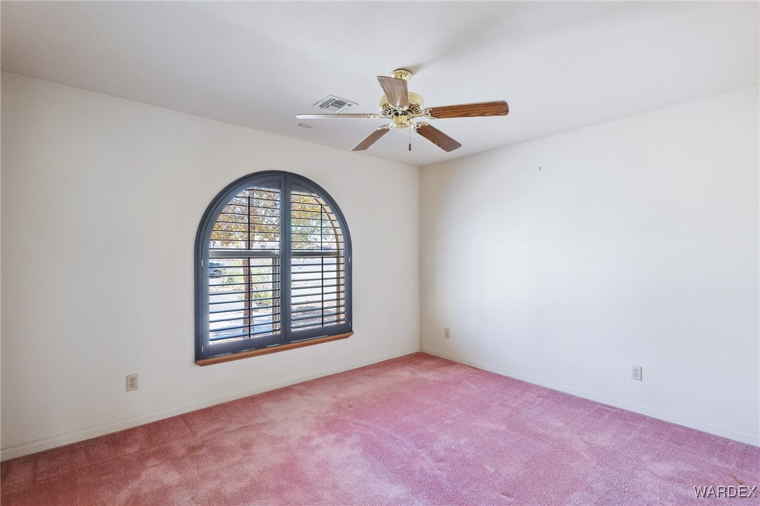 5967 Mountain View Road Fort Mohave, AZ 86426 - Photo 7 of 18 an empty room with windows and fan