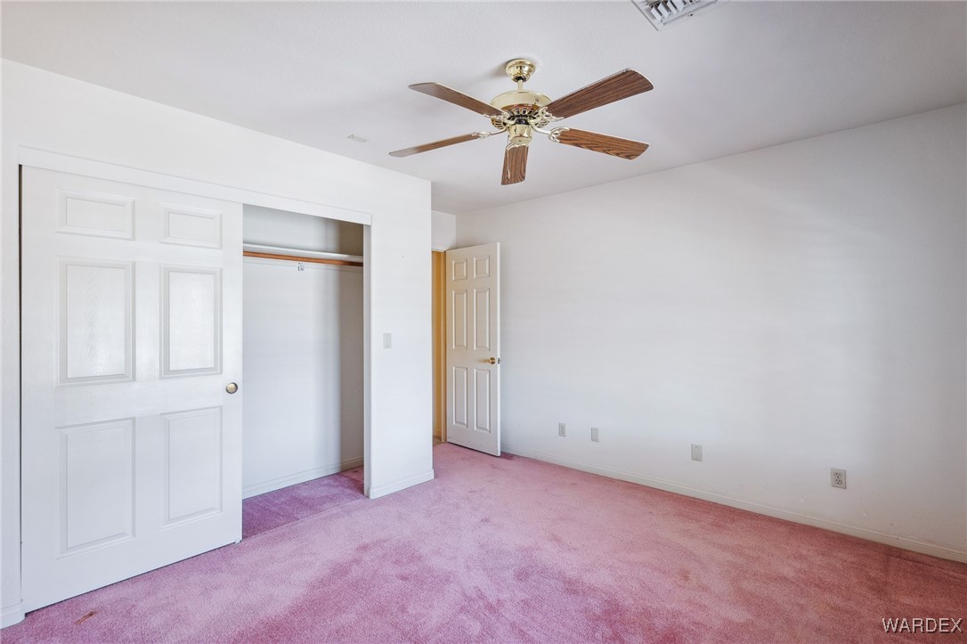 5967 Mountain View Road Fort Mohave, AZ 86426 - Photo 8 of 18 an empty room with closet and fan
