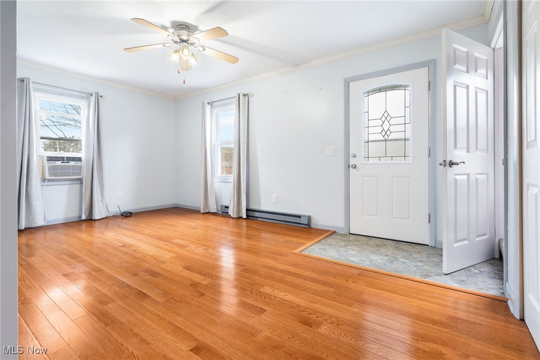 3696 Lynn Road Ravenna, OH 44266 - Photo 6 of 25 Entrance foyer featuring crown molding, light hardwood / wood-style flooring, and cooling unit