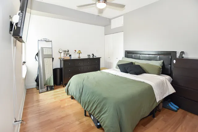 a bedroom with a bed and a flat screen tv