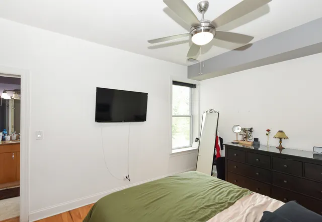 a white toilet sitting next to a bath tub