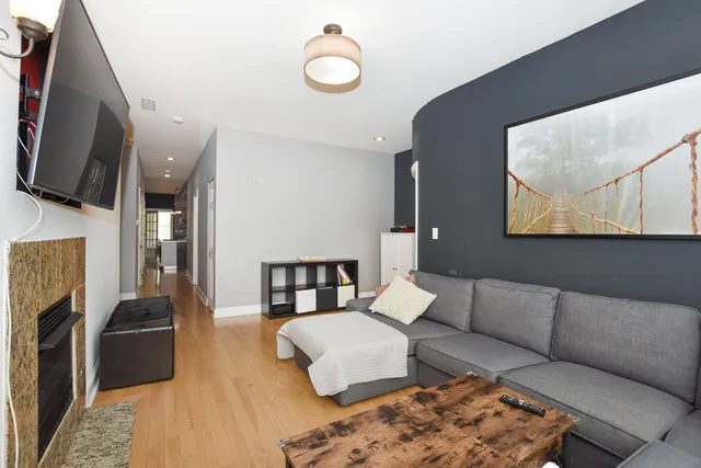 a view of a hallway with wooden floor and windows