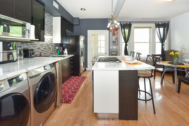 a kitchen with a table chairs stove and cabinets