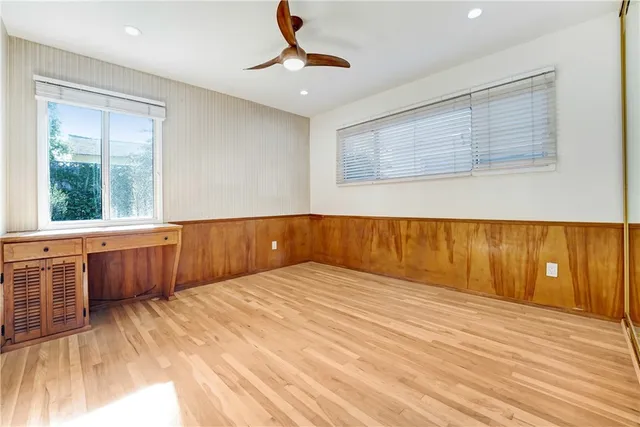 a view of a room with wooden floor and window