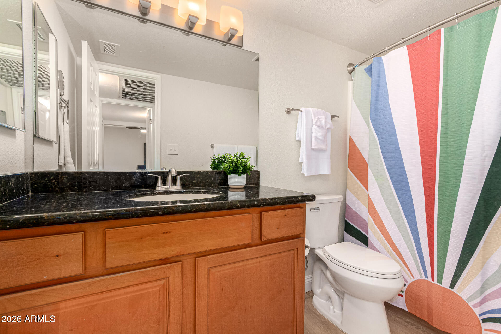 5877 North Granite Reef Road, Unit 1133 Scottsdale, AZ 85250 - Photo 14 of 33 a bathroom with a sink a mirror a toilet and a window